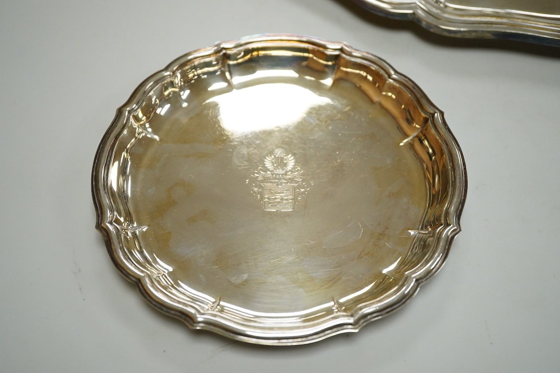 A German 800 standard white metal salver, diameter 35.9cm, together with a similar waiter, diameter 15.6cm, both with engraved armorial, 35oz.